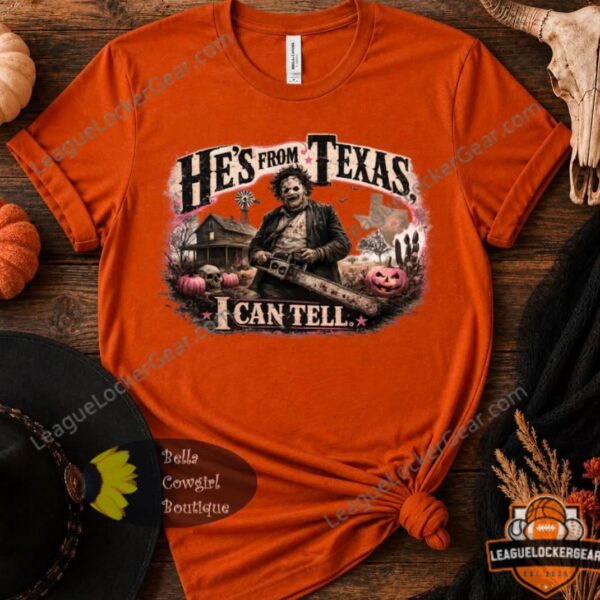 Leatherface He's From Texas I Can Tell Halloween T-Shirt - front view on wooden background with pumpkins
