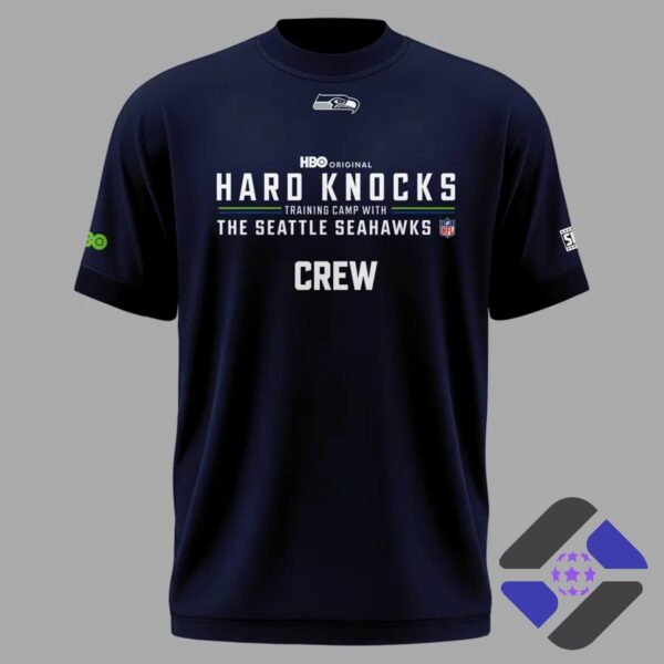 Seattle Seahawks Hard Knocks Training Camp Crew 2026 T-Shirt - smiling man holding shirt, front 'Hard Knocks'