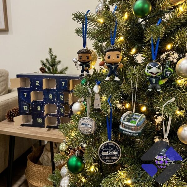 Eight Seattle Seahawks Funko Pop figures and three championship trophies displayed