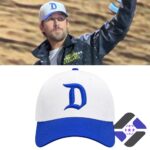 Ryan Gosling wearing a white and blue 'D' logo cap, with the cap also displayed as a standalone product
